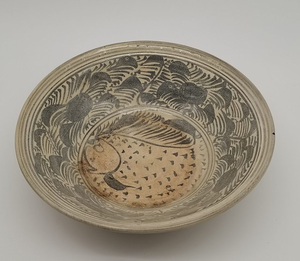 Saucer Dish, decorated in center medallion of fish. KenSoon Asiatic